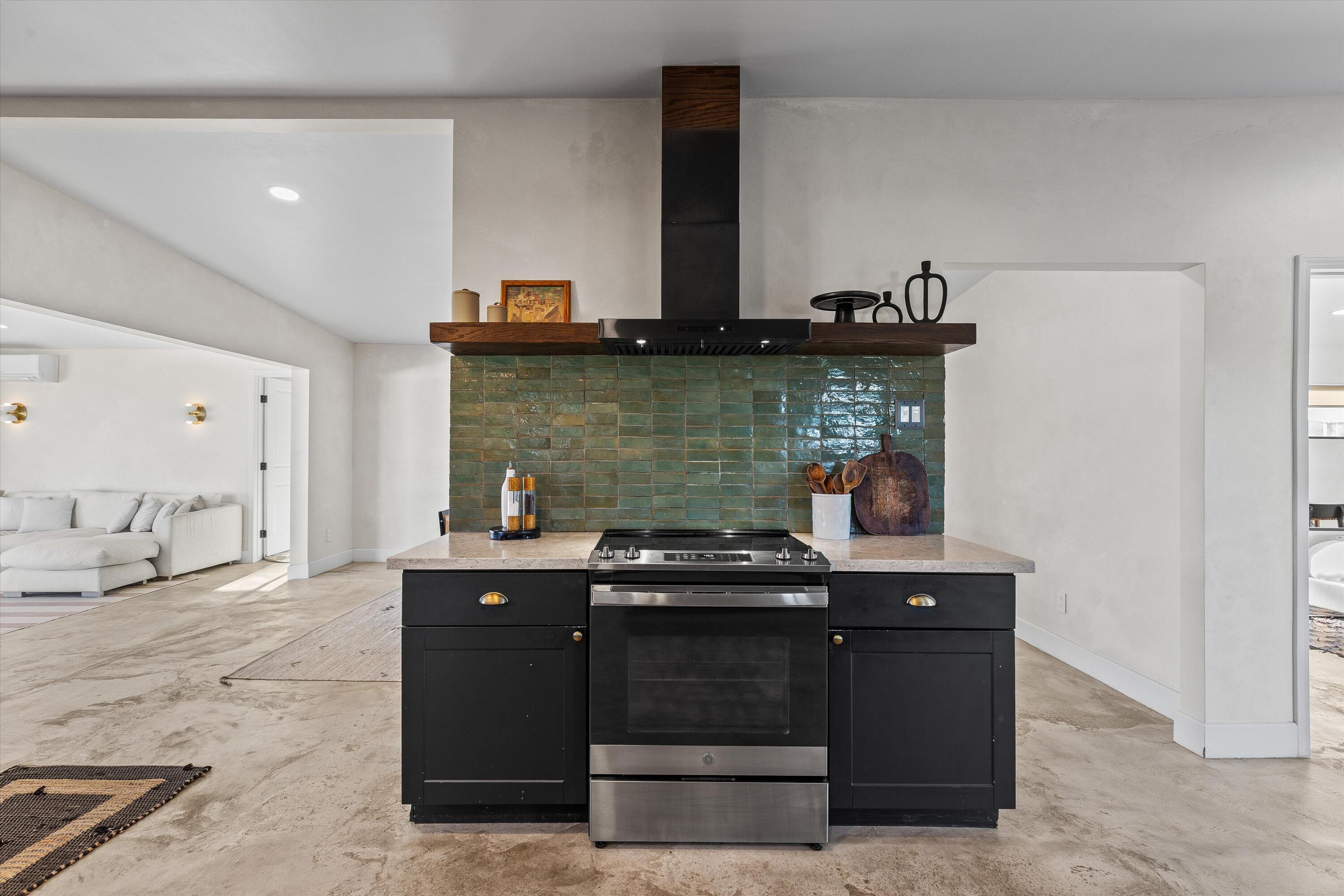 4610 Sunkist Road Joshua Tree, CA 92252 - Photo 17 of 55 a kitchen with stainless steel appliances granite countertop a stove and cabinets