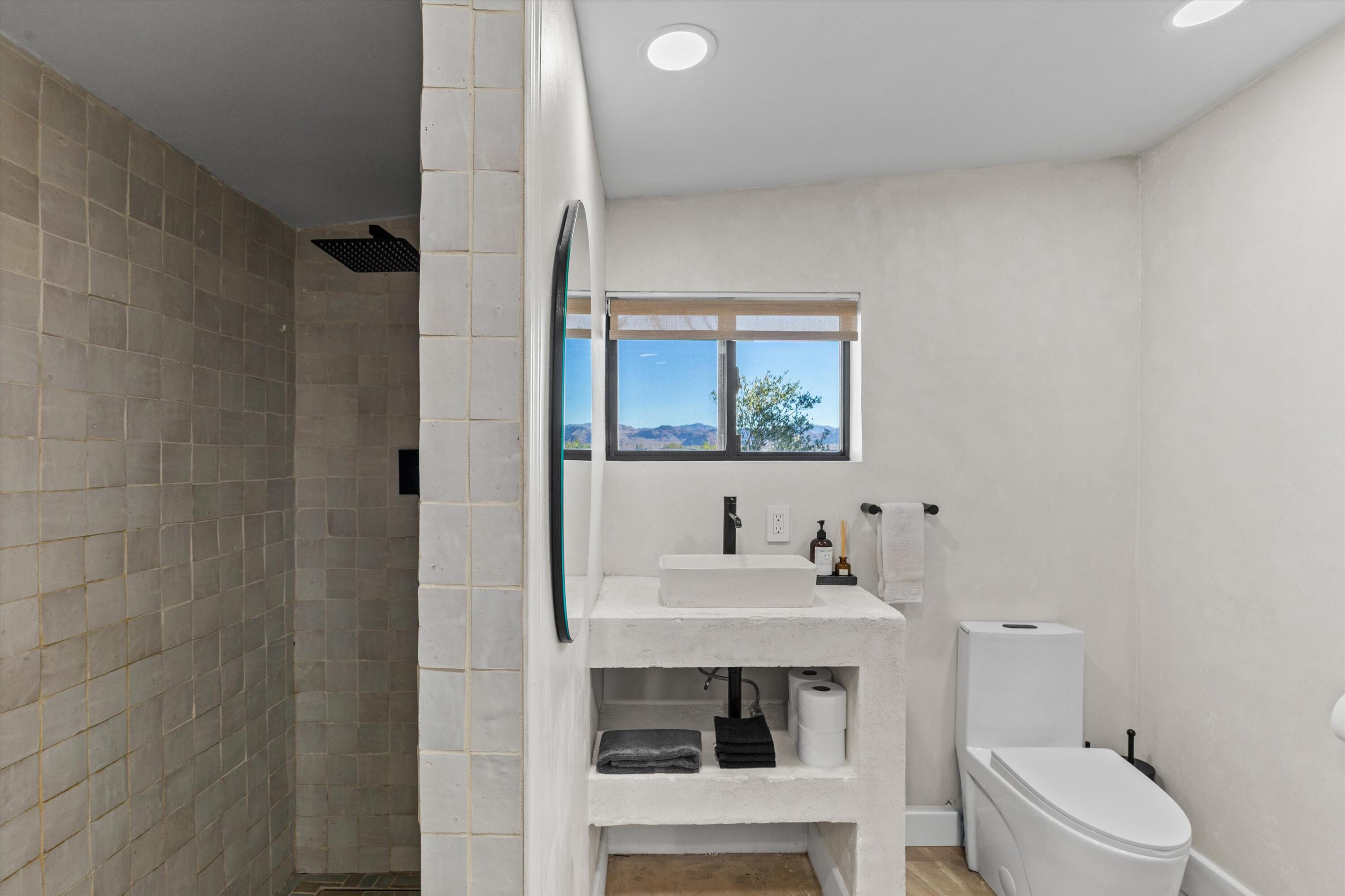 4610 Sunkist Road Joshua Tree, CA 92252 - Photo 21 of 55 a bathroom with a sink toilet and mirror