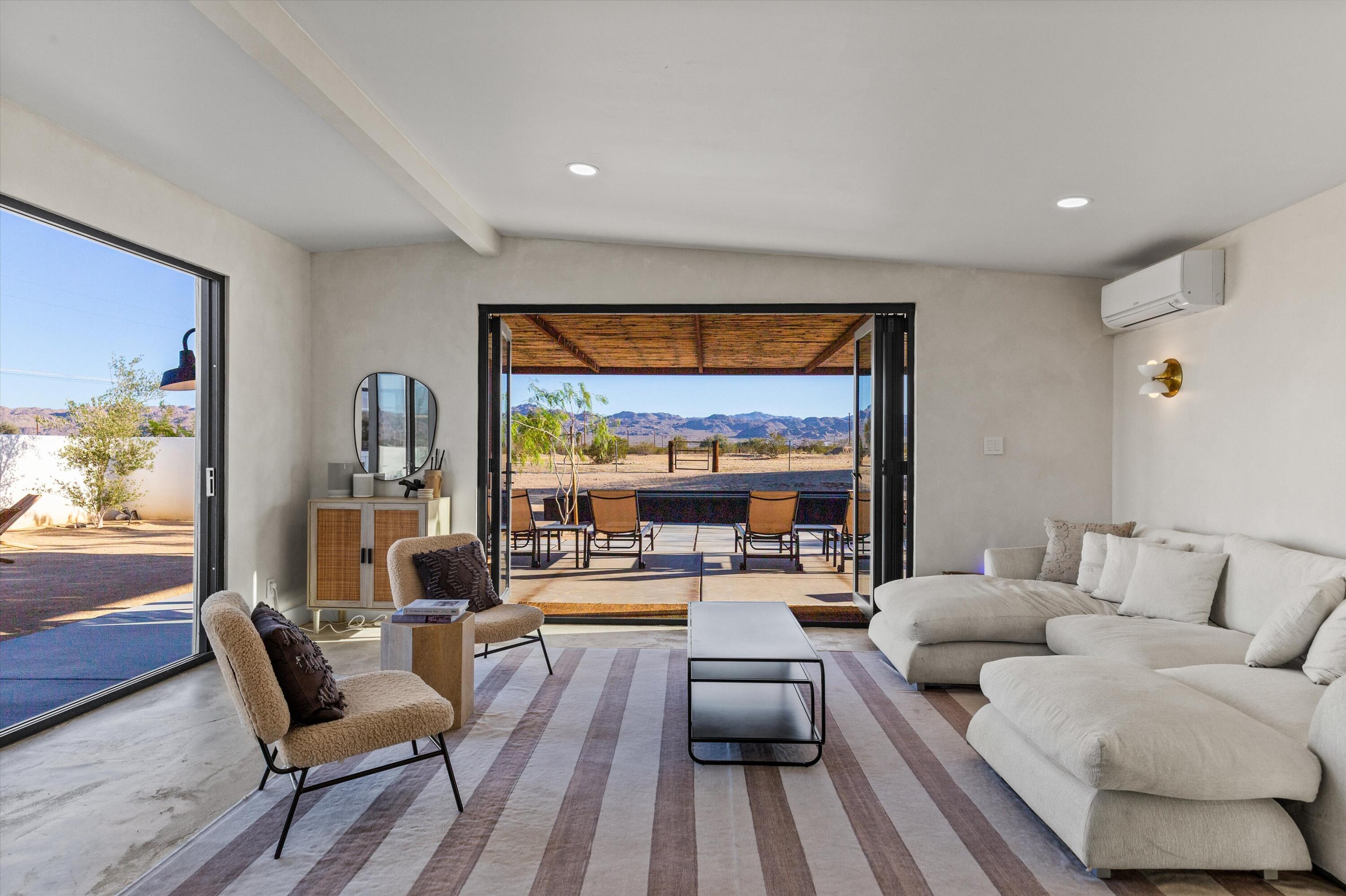 4610 Sunkist Road Joshua Tree, CA 92252 - Photo 26 of 55 a living room with furniture and a large window