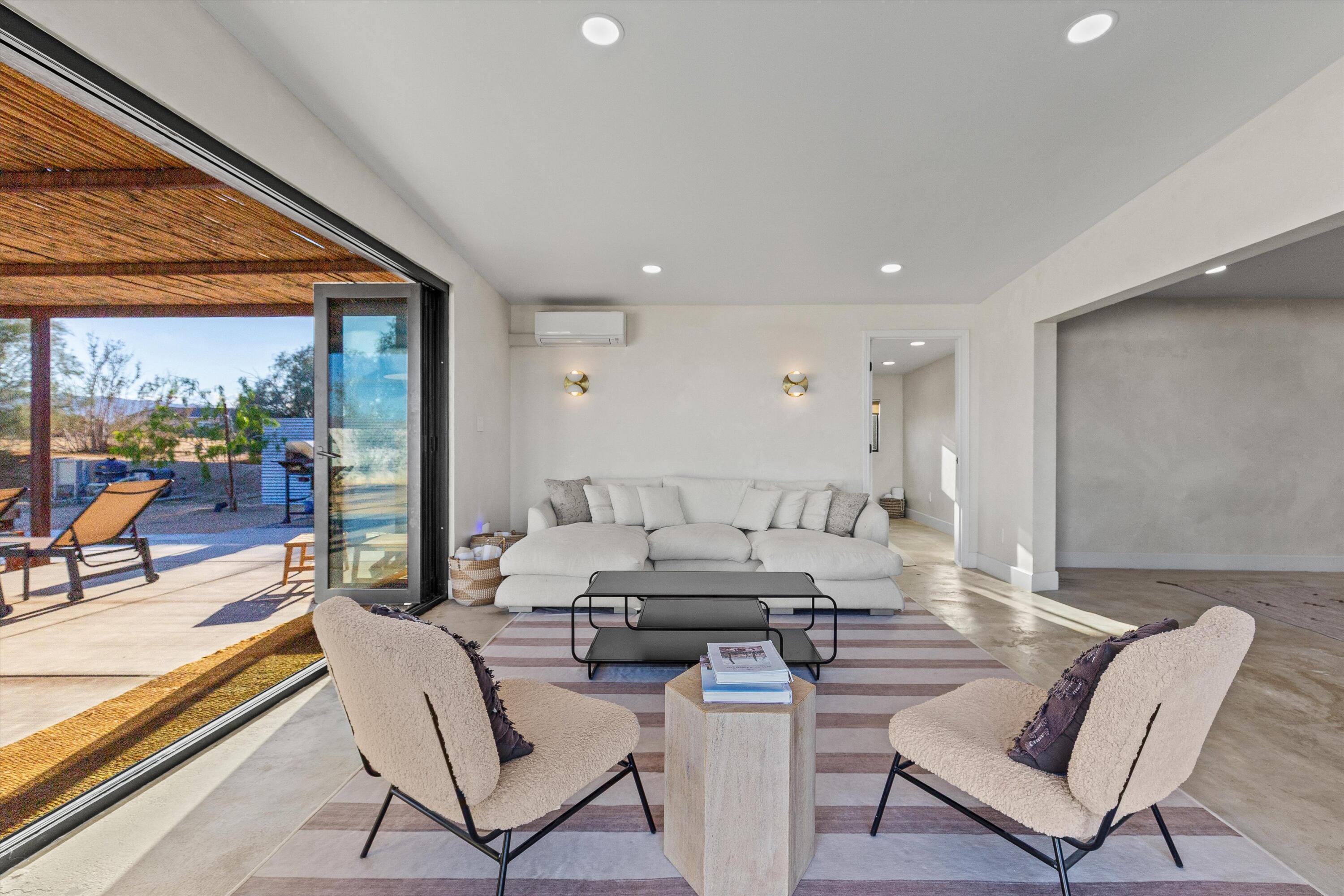 4610 Sunkist Road Joshua Tree, CA 92252 - Photo 27 of 55 a living room with furniture and a large window