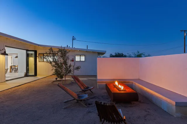 a bedroom with a large bed and a night stand