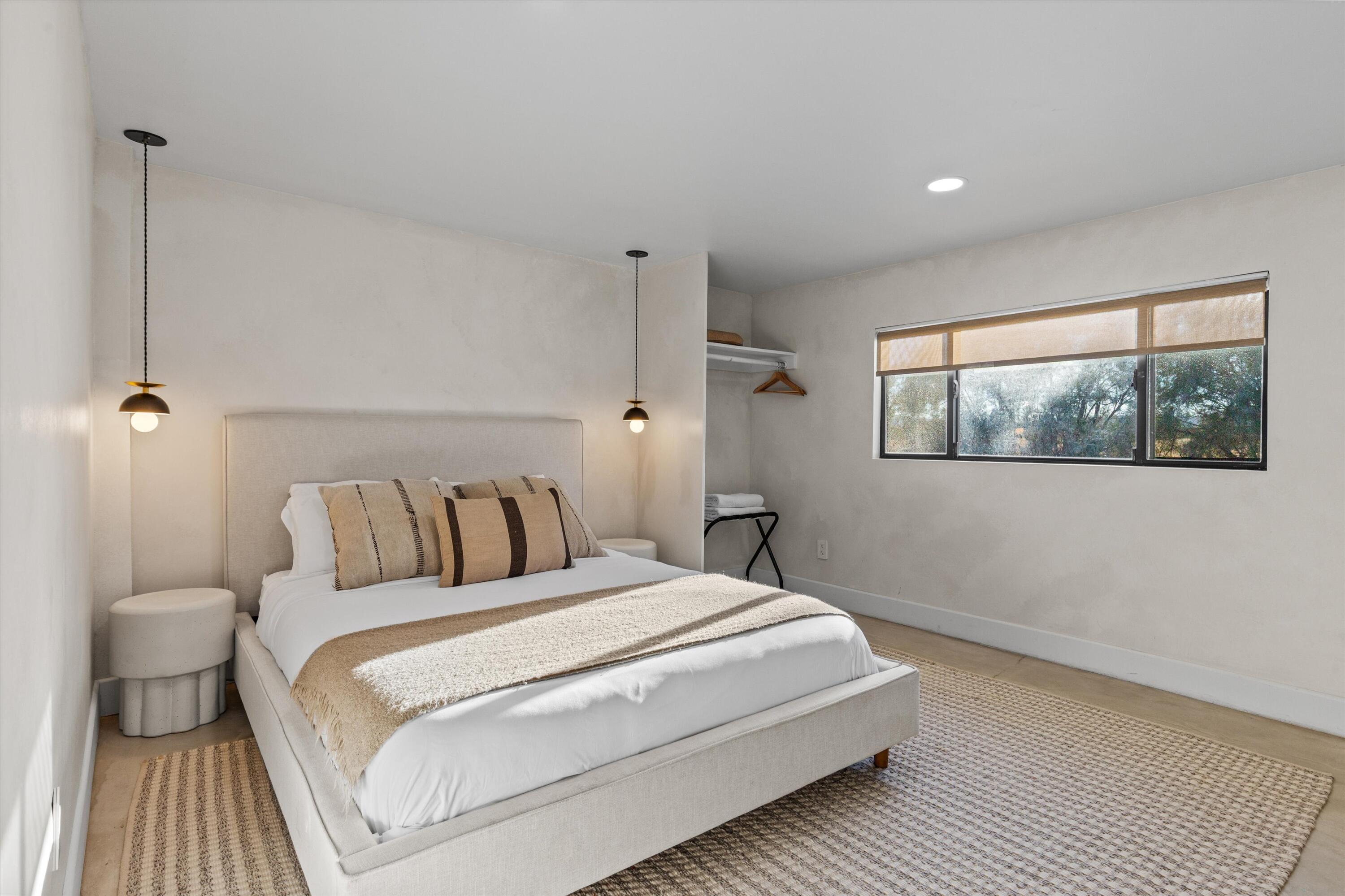 4610 Sunkist Road Joshua Tree, CA 92252 - Photo 42 of 55 a bedroom with a large bed and a night stand