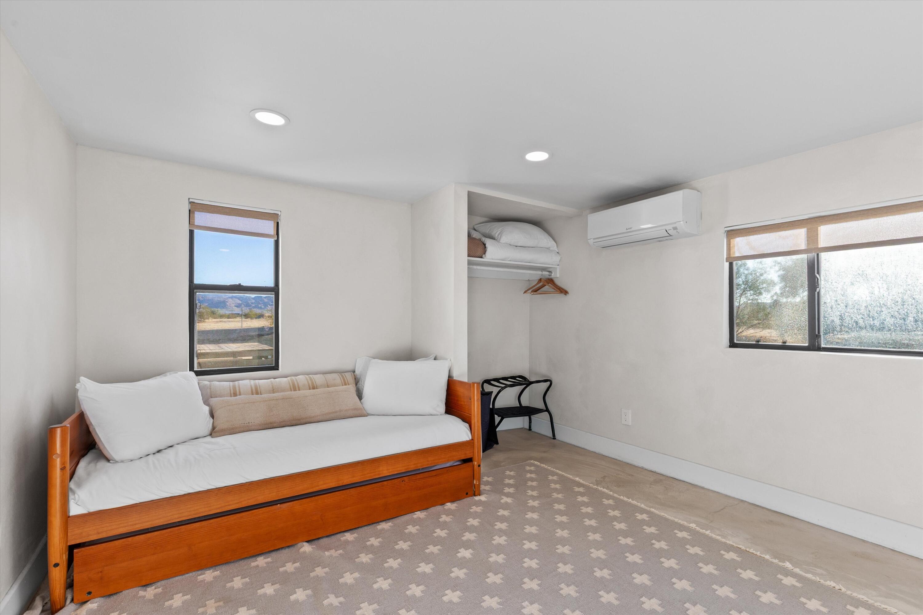 4610 Sunkist Road Joshua Tree, CA 92252 - Photo 44 of 55 a bedroom with a bed and wooden floor