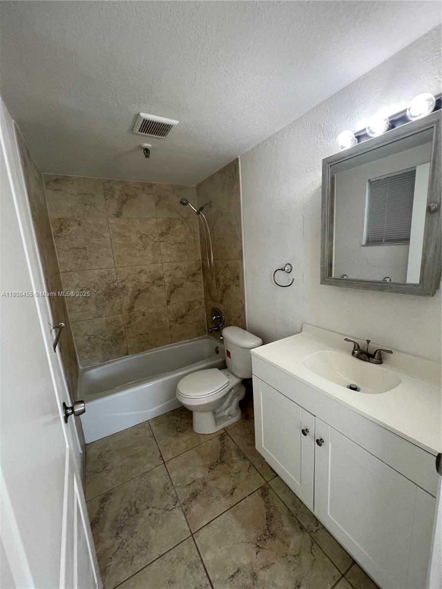 677 Northeast 24th Street, Unit 607 Miami, FL 33137 - Photo 19 of 29 a bathroom with a toilet sink and mirror