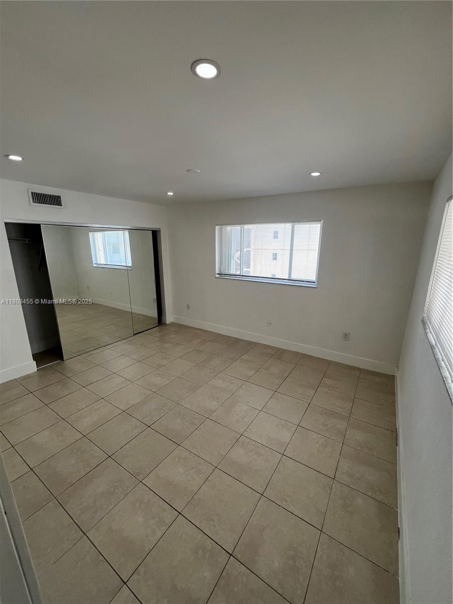 677 Northeast 24th Street, Unit 607 Miami, FL 33137 - Photo 20 of 29 an empty room with windows and fireplace