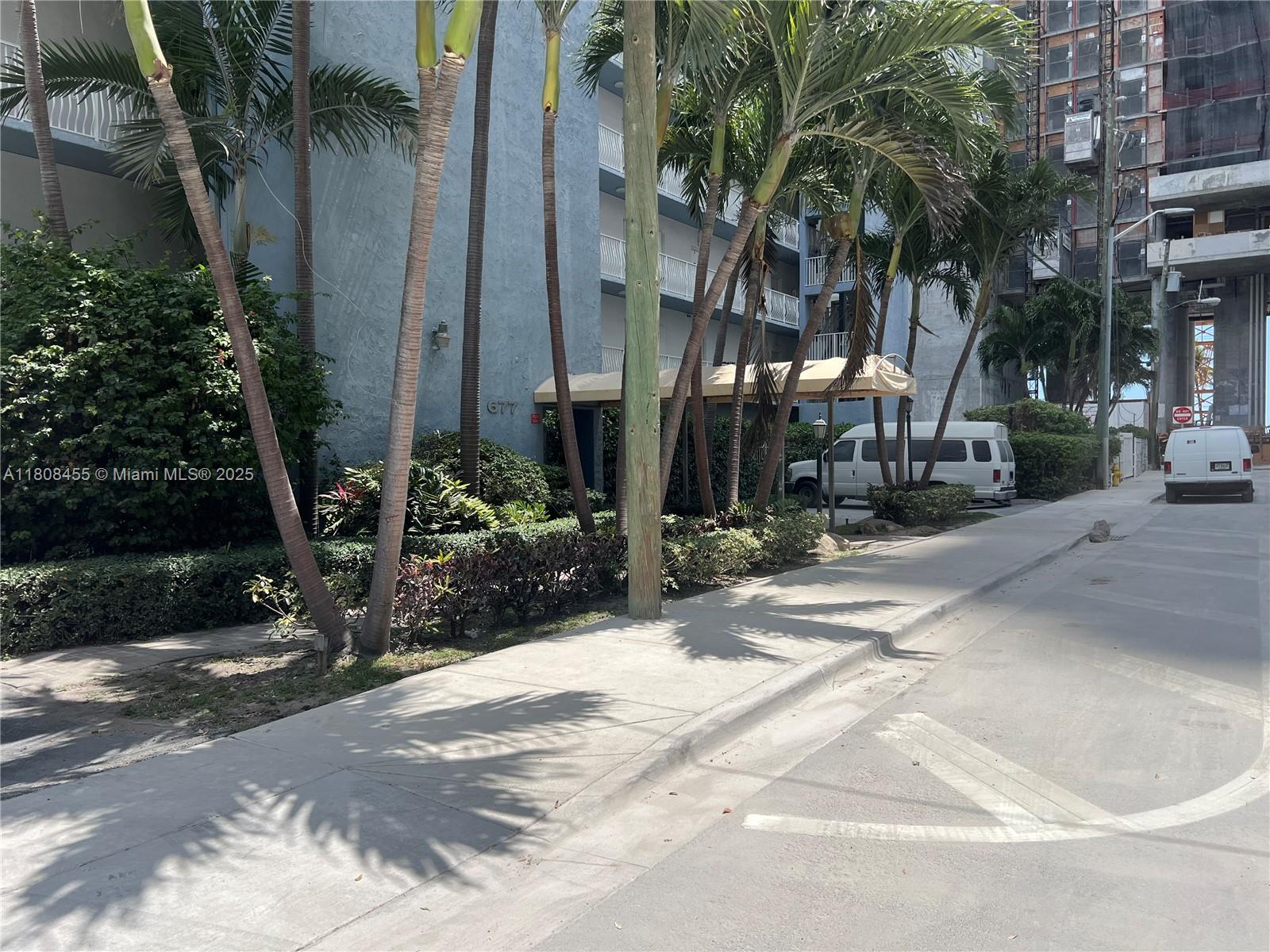 677 Northeast 24th Street, Unit 607 Miami, FL 33137 - Photo 2 of 29 a view of a building along trees