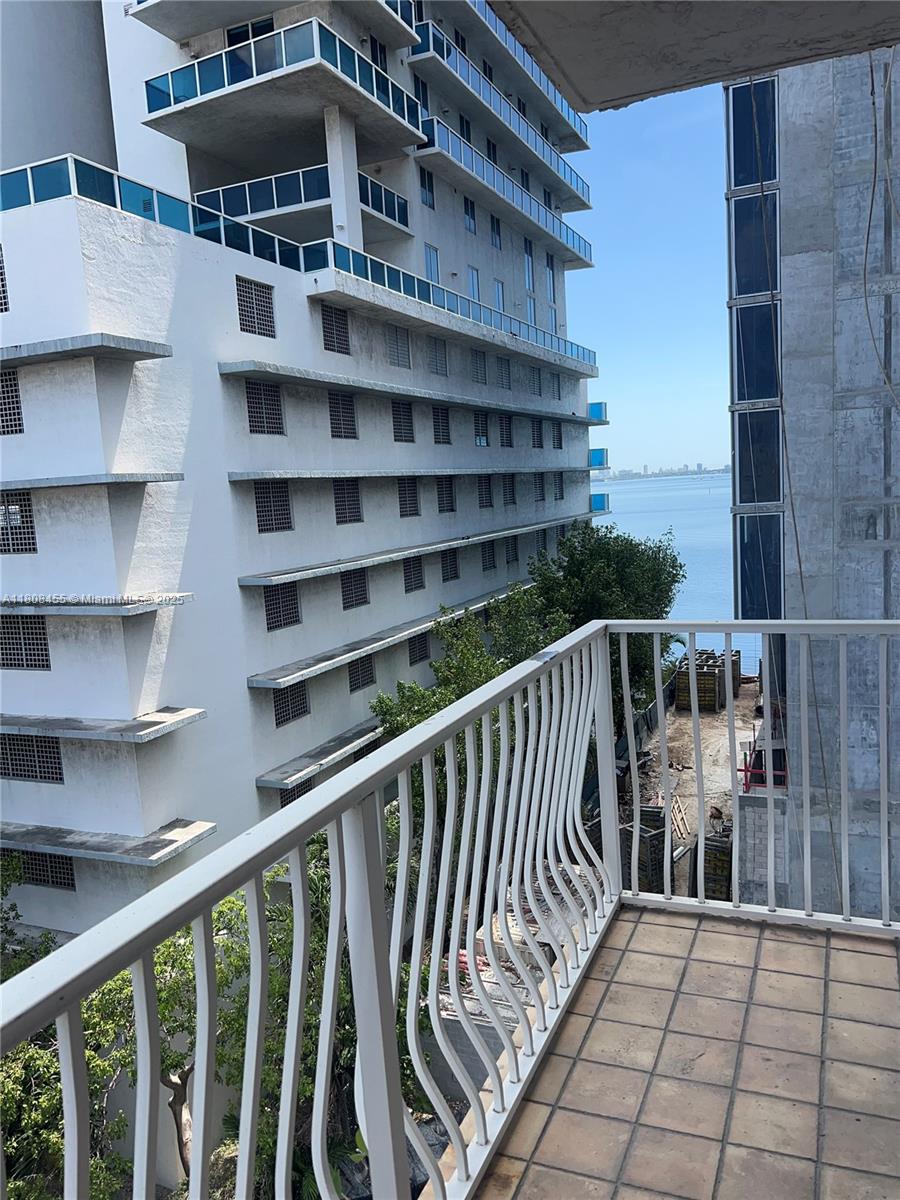 677 Northeast 24th Street, Unit 607 Miami, FL 33137 - Photo 26 of 29 a balcony with a book shelf