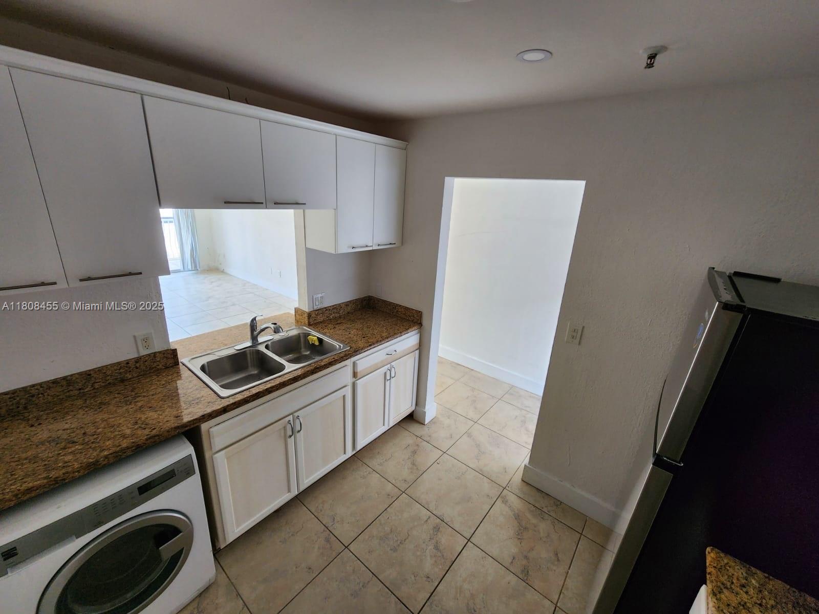 677 Northeast 24th Street, Unit 607 Miami, FL 33137 - Photo 9 of 29 a kitchen with a stove and a refrigerator