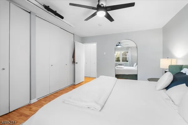 a bedroom with a large bed and a large window