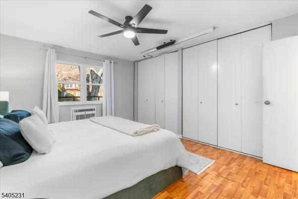 a bedroom with a bed and a large window