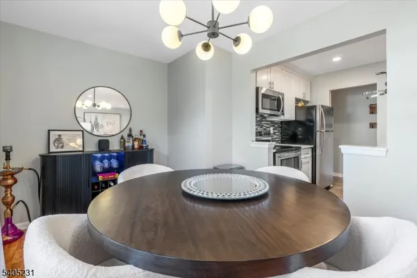 a living room with dining table and chairs