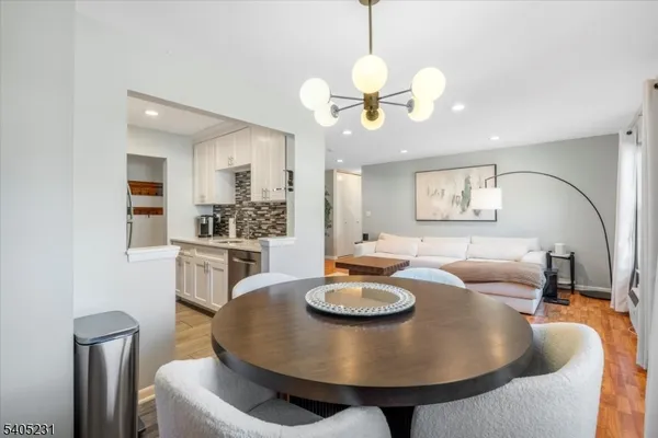 a kitchen with granite countertop a sink stove and refrigerator