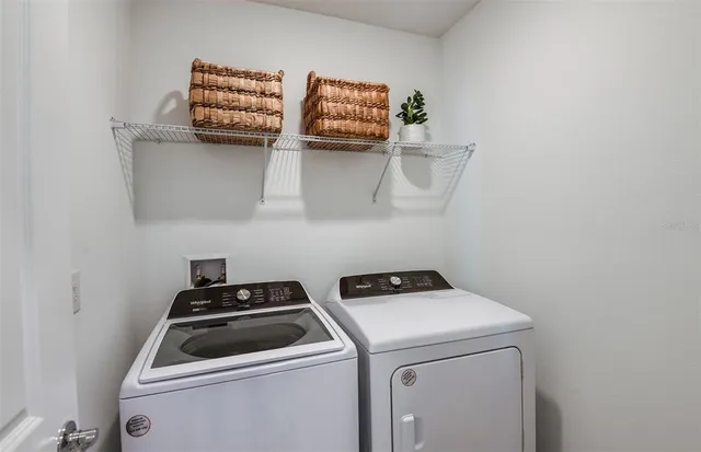 a utility room with dryer washer and sink