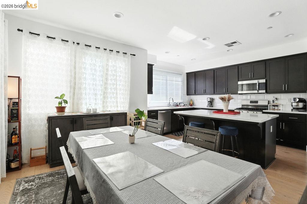 863 Lookout Street Richmond, CA 94804 - Photo 13 of 42 Dining room with light wood-style floors and recessed lighting