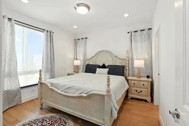 a bedroom with a bed and a mirror