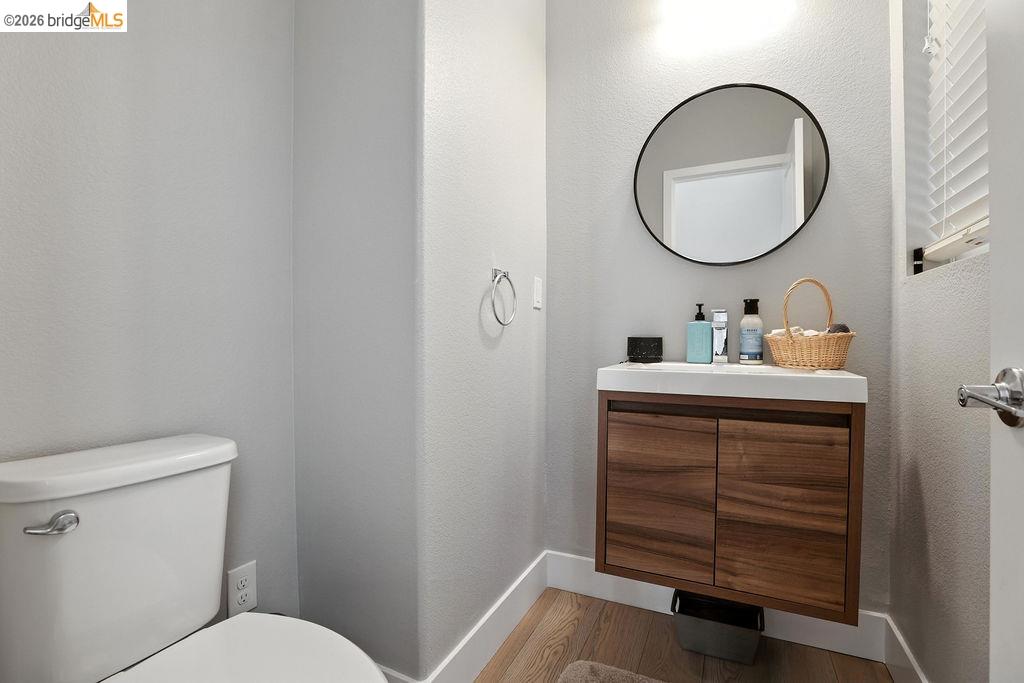 863 Lookout Street Richmond, CA 94804 - Photo 7 of 42 Bathroom featuring vanity, a textured wall, and wood finished floors