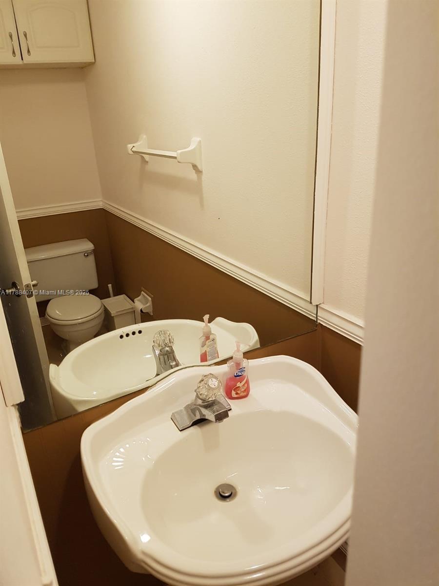 3740 Inverrary Drive, Unit 3D Lauderhill, FL 33319 - Photo 12 of 20 a bathroom with a sink and mirror