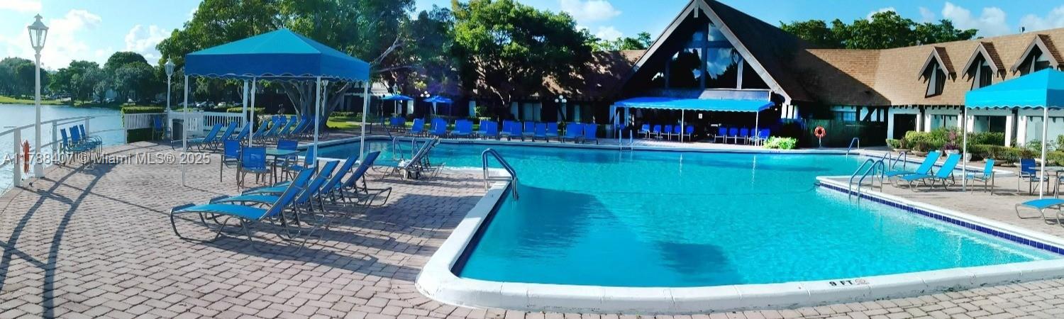 3740 Inverrary Drive, Unit 3D Lauderhill, FL 33319 - Photo 19 of 20 a view of a house with backyard water fountain and sitting area