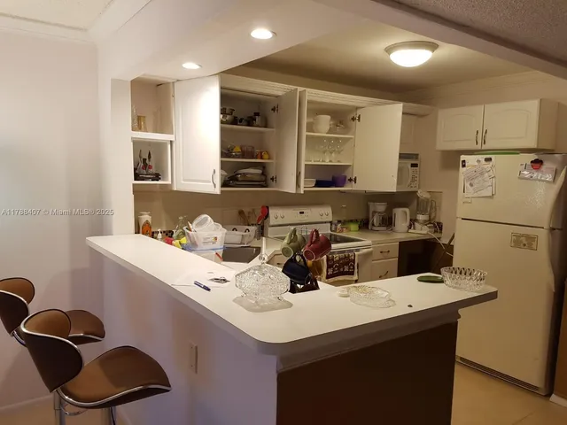 a kitchen with a sink cabinets and wooden floor