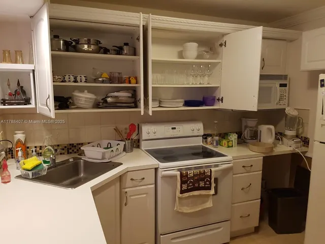 a utility room with sink dryer and washer