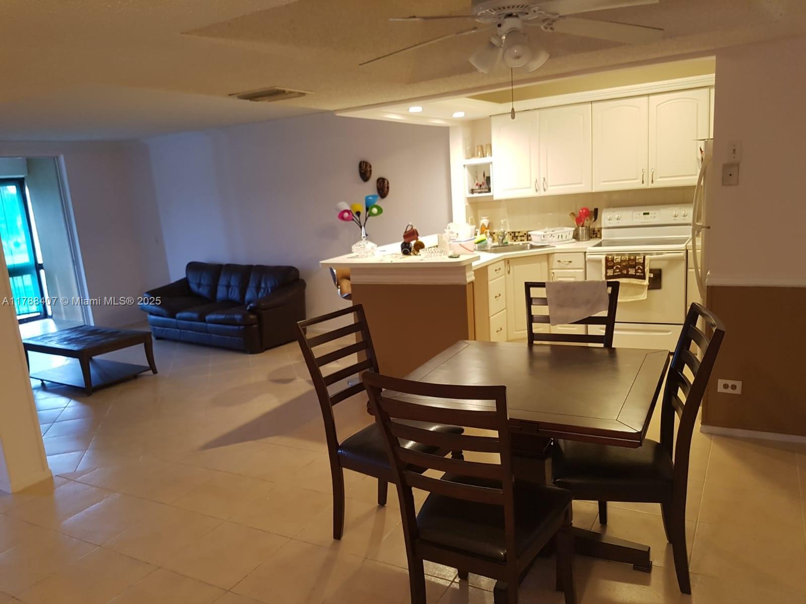 3740 Inverrary Drive, Unit 3D Lauderhill, FL 33319 - Photo 5 of 20 a view of a dining room with furniture and a window
