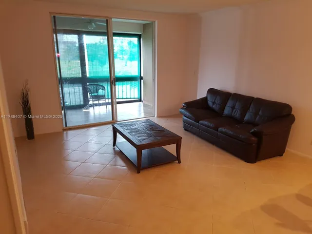 a living room with furniture rug and a large window