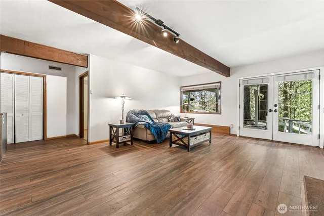 a living room with furniture and a wooden floor