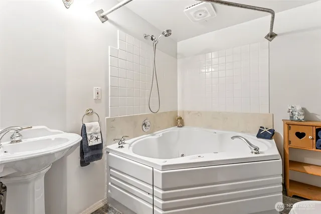 a white bath tub sitting next to a white sink