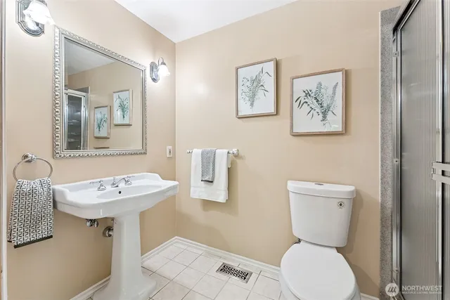 a bathroom with a toilet a sink and a mirror