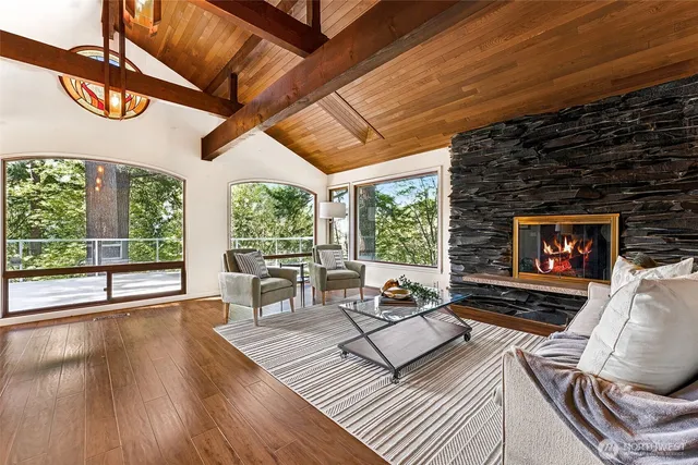 a living room with furniture a fireplace and a flat screen tv