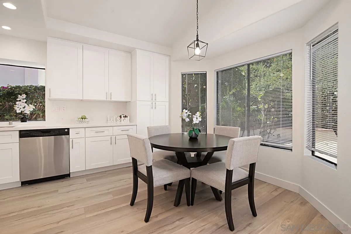 4256 Caminito Terviso San Diego, CA 92122 - Photo 13 of 32 a view of a dining room with furniture window and wooden floor