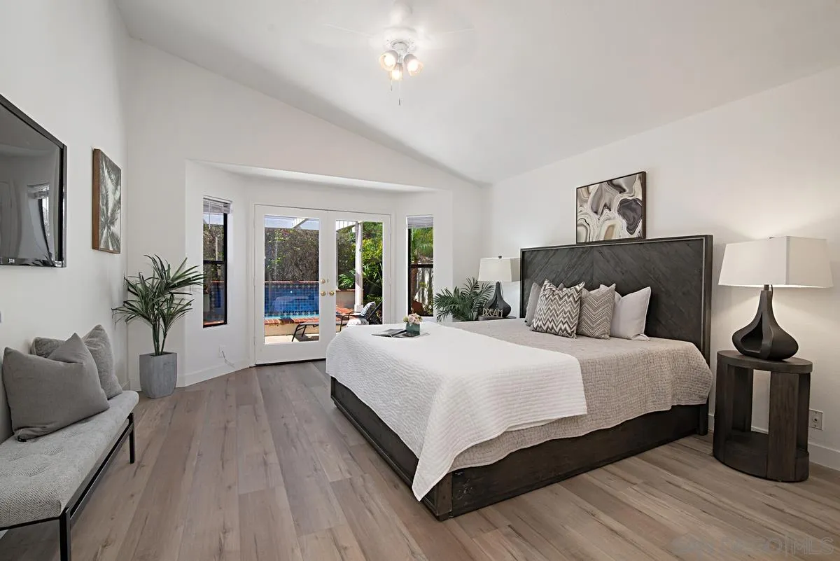 4256 Caminito Terviso San Diego, CA 92122 - Photo 18 of 32 a large bedroom with a bed and wooden floor