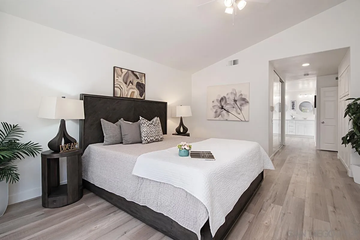 4256 Caminito Terviso San Diego, CA 92122 - Photo 20 of 32 a large bed sitting in a bedroom and a table