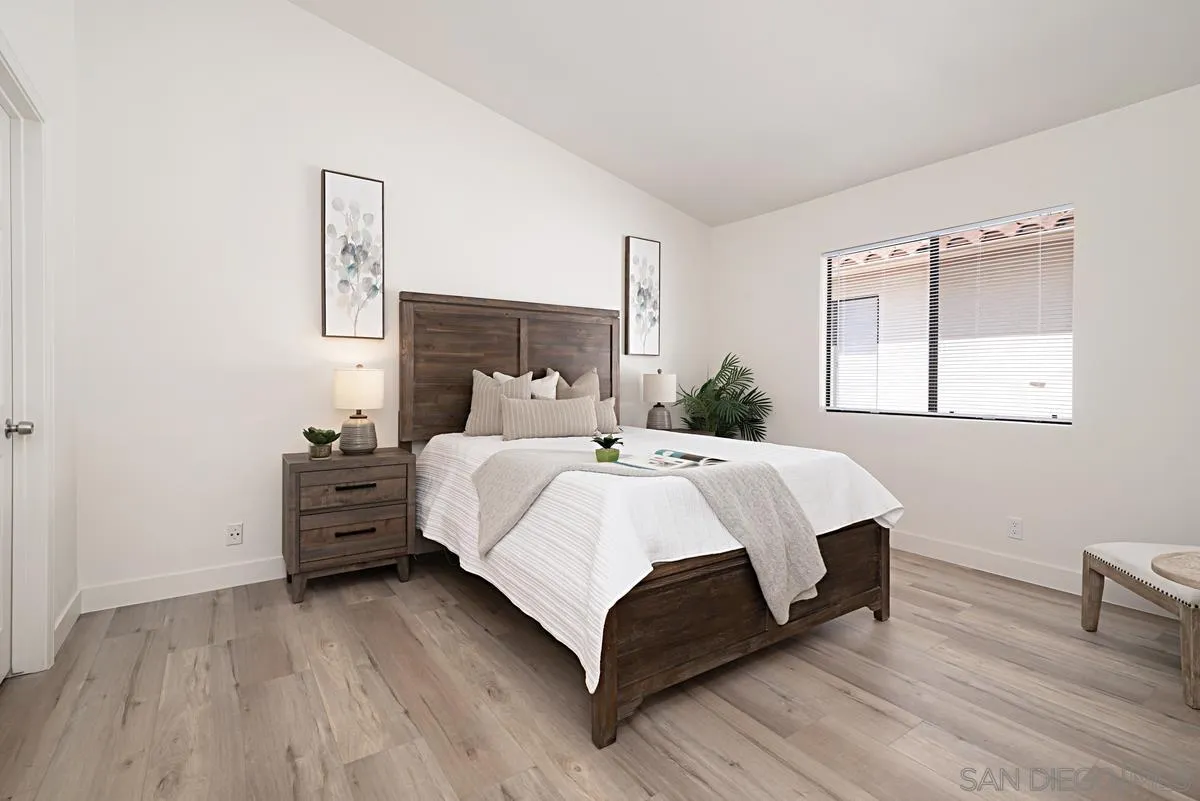 4256 Caminito Terviso San Diego, CA 92122 - Photo 22 of 32 a bedroom with a bed lamp closet and window