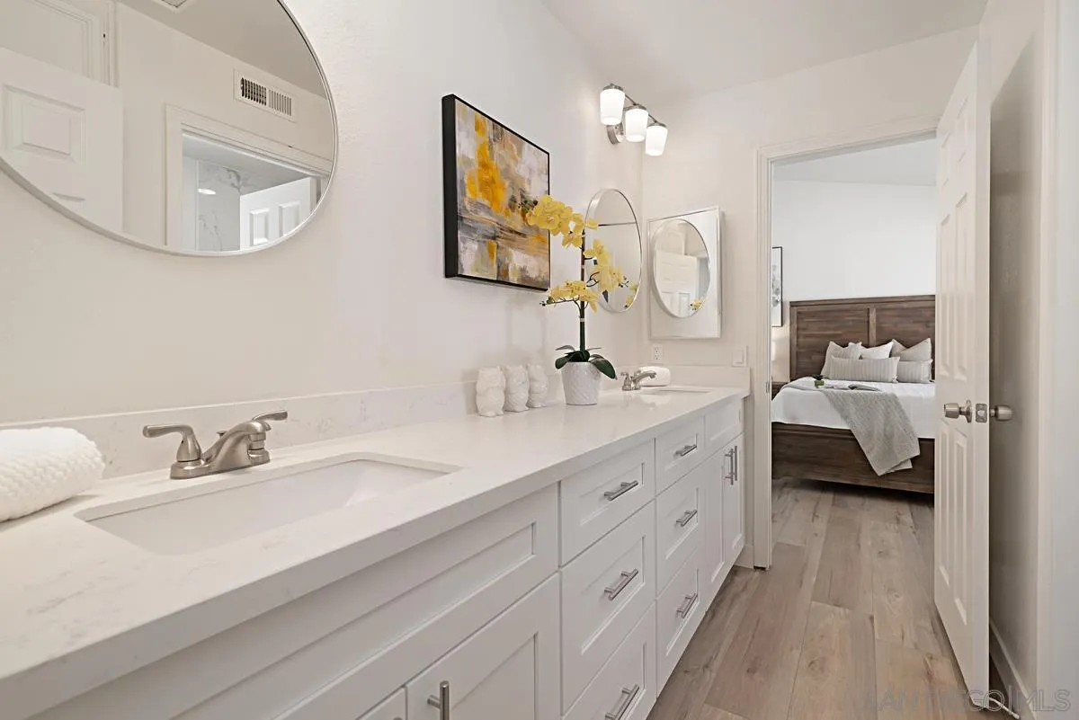 4256 Caminito Terviso San Diego, CA 92122 - Photo 24 of 32 a en suite bathroom with a double vanity sink and a mirror