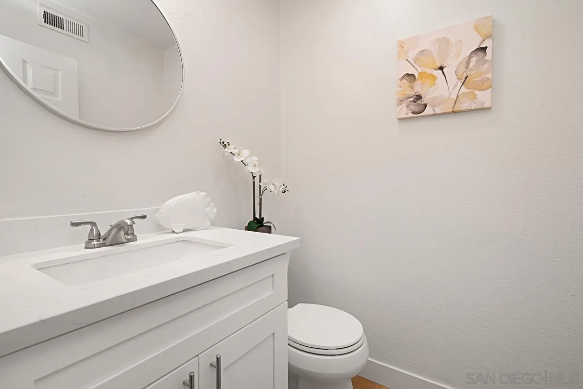 4256 Caminito Terviso San Diego, CA 92122 - Photo 26 of 32 a bathroom with a sink mirror vanity and toilet