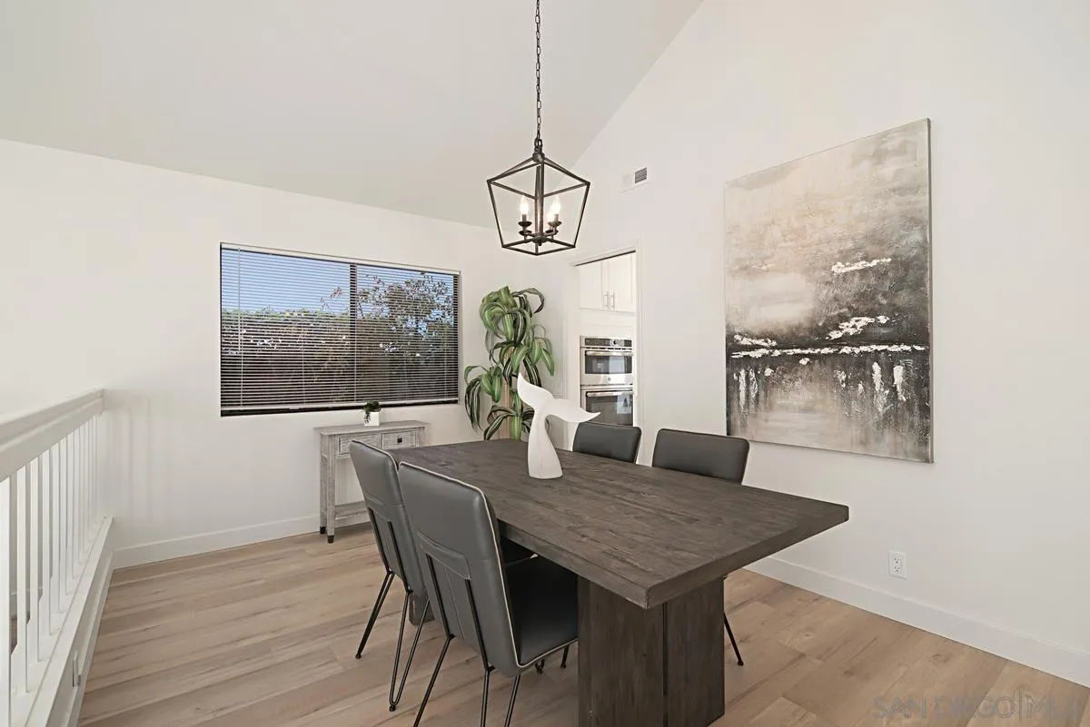 4256 Caminito Terviso San Diego, CA 92122 - Photo 8 of 32 a view of a dining room with furniture window and wooden floor