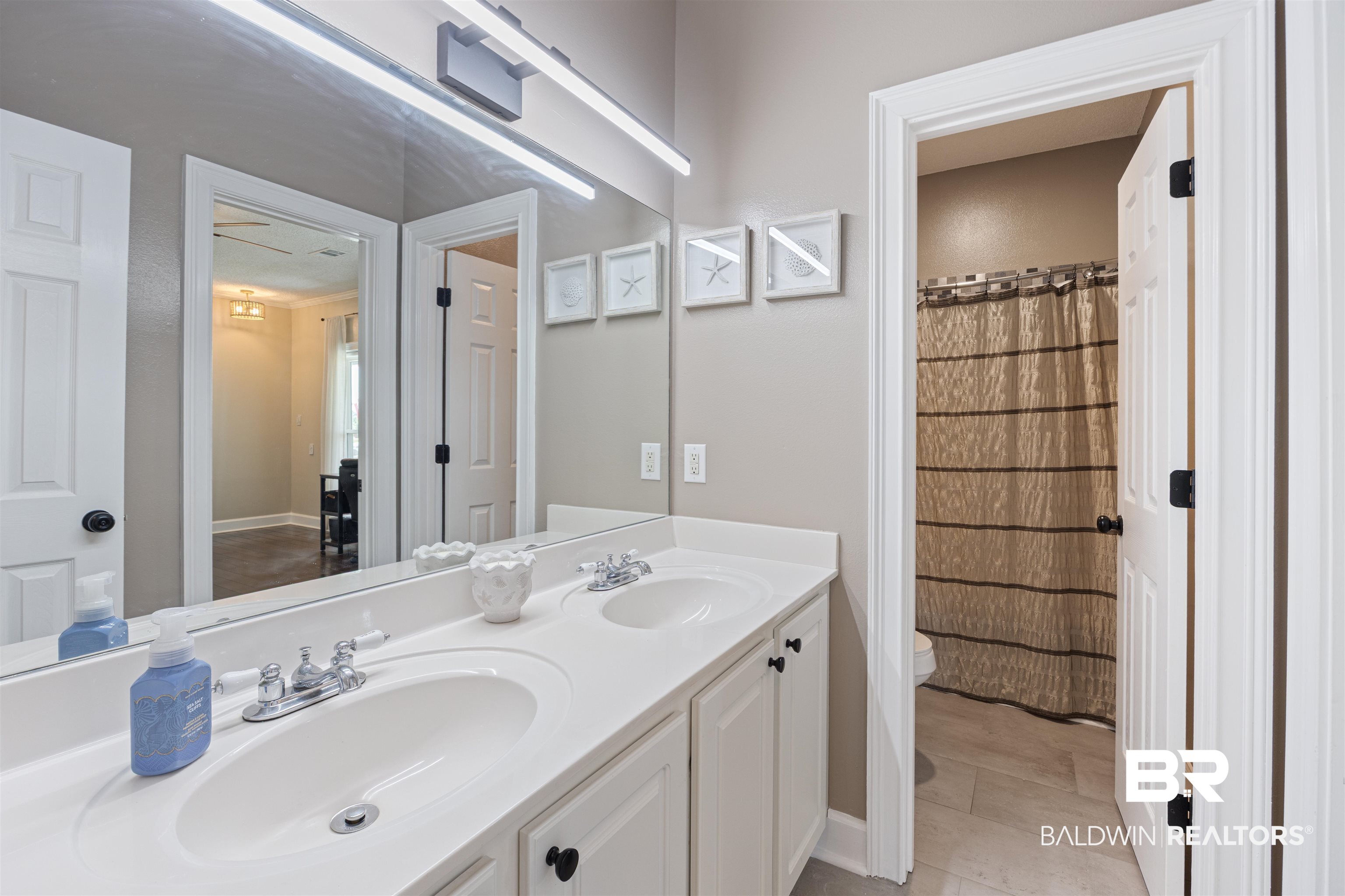9855 Stucki Road Elberta, AL 36530 - Photo 40 of 54 Bathroom with double vanity and a shower with shower curtain