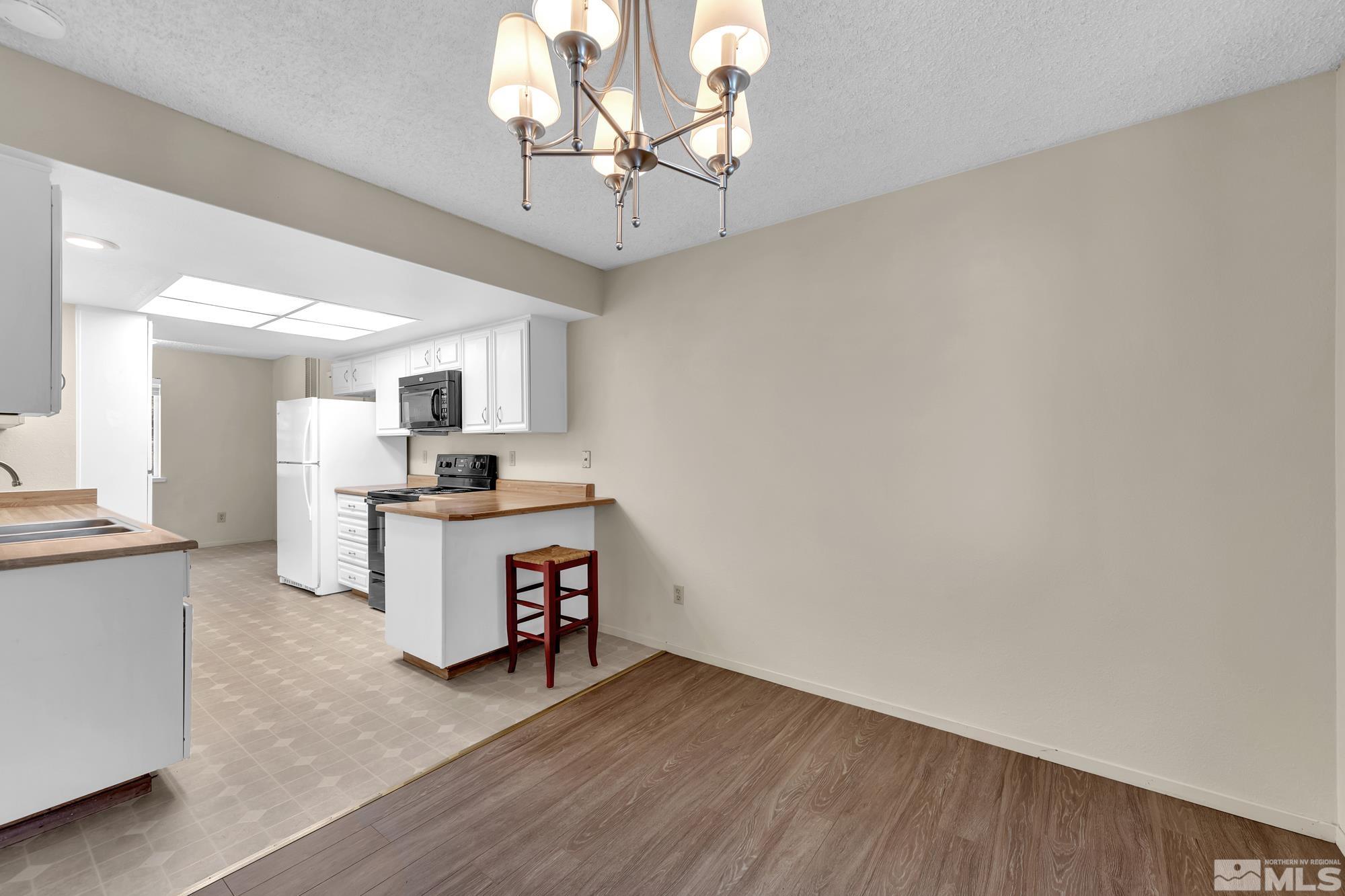 6025 Conness Way Reno, NV 89523 - Photo 11 of 30 a living room with furniture and a chandelier