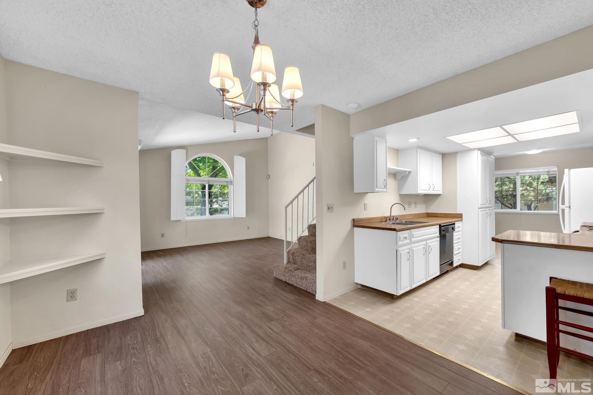 6025 Conness Way Reno, NV 89523 - Photo 13 of 30 a kitchen with stainless steel appliances granite countertop a oven a stove a refrigerator and a wooden floors