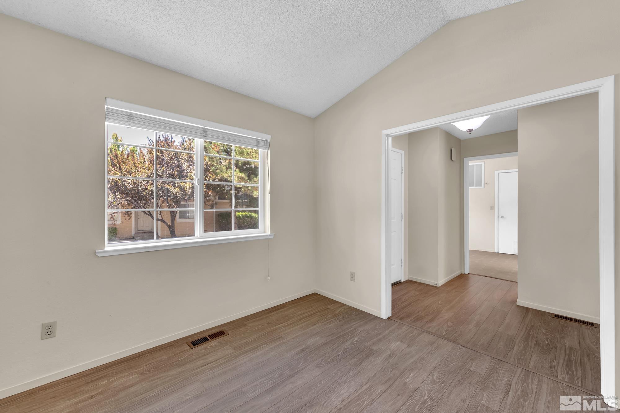 6025 Conness Way Reno, NV 89523 - Photo 29 of 30 a view of an empty room with wooden floor and a window