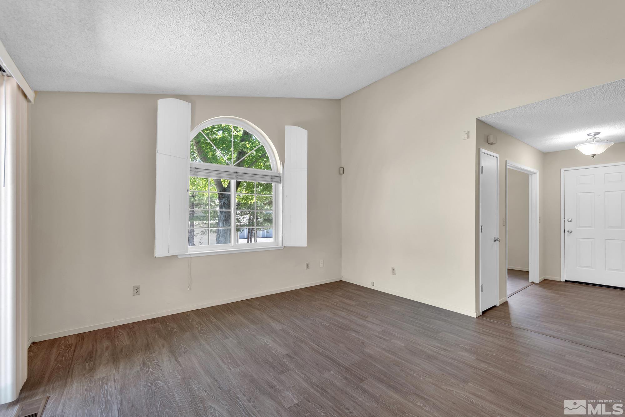 6025 Conness Way Reno, NV 89523 - Photo 5 of 30 an empty room with wooden floor and windows