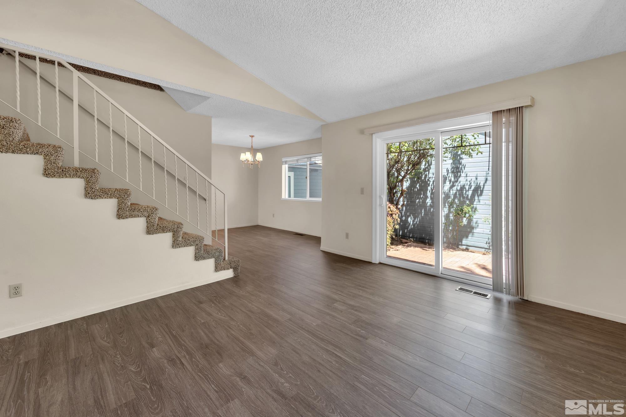 6025 Conness Way Reno, NV 89523 - Photo 8 of 30 a view of an empty room with wooden floor and a window