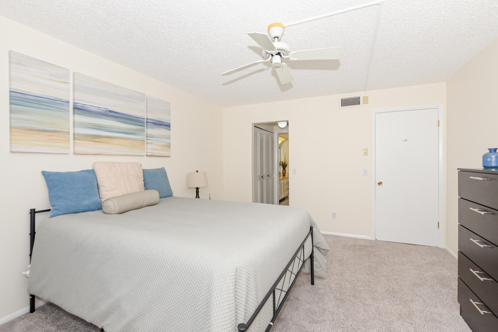 1950 Southwest Palm City Road, Unit 12103 Stuart, FL 34994 - Photo 17 of 26 a bedroom with a bed and a chandelier