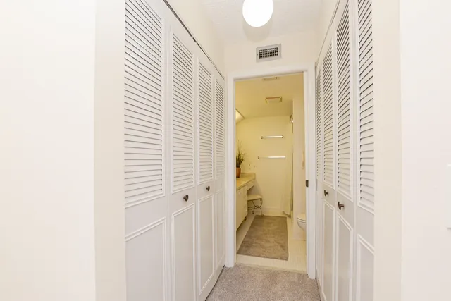 a view of a bathroom from a hallway
