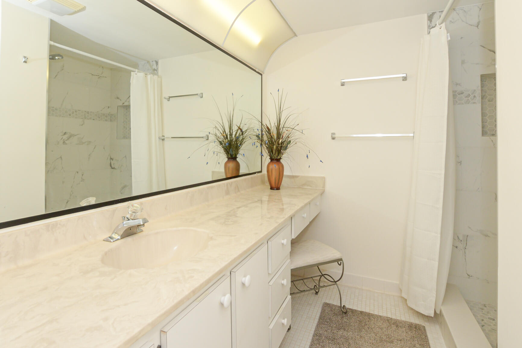 1950 Southwest Palm City Road, Unit 12103 Stuart, FL 34994 - Photo 22 of 26 a bathroom with a sink and mirror