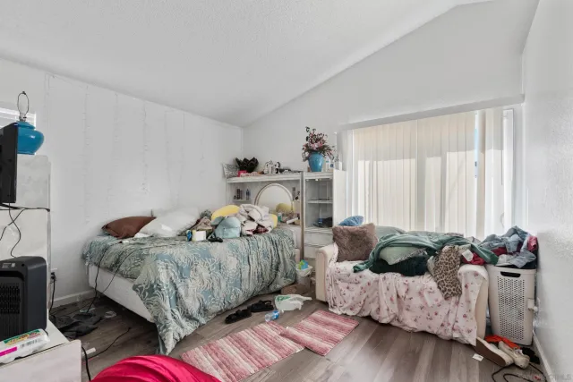 a bedroom with two beds and a desk