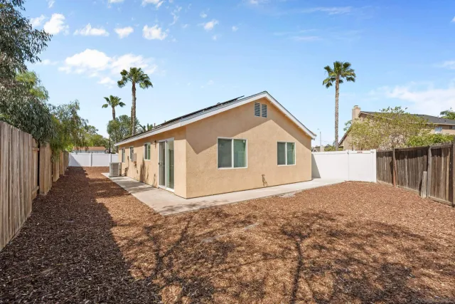 a view of a kitchen with furniture and an empty room
