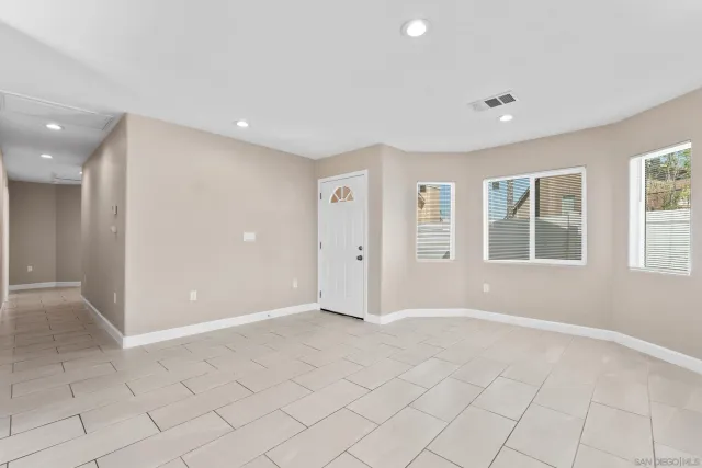 a kitchen with stainless steel appliances kitchen island granite countertop a refrigerator and a stove top oven