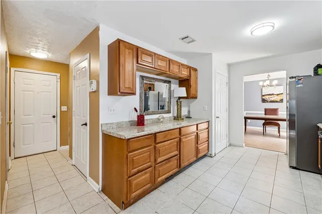 a spacious bathroom with a granite countertop sink and a mirror